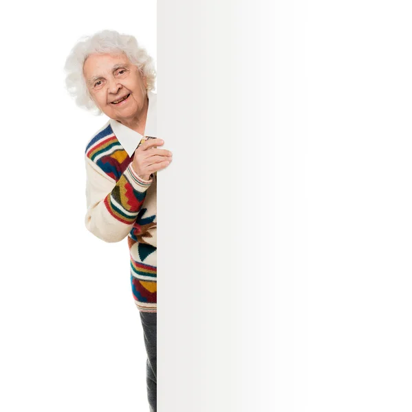 Elderly woman alongside of ad board — Stock Photo, Image