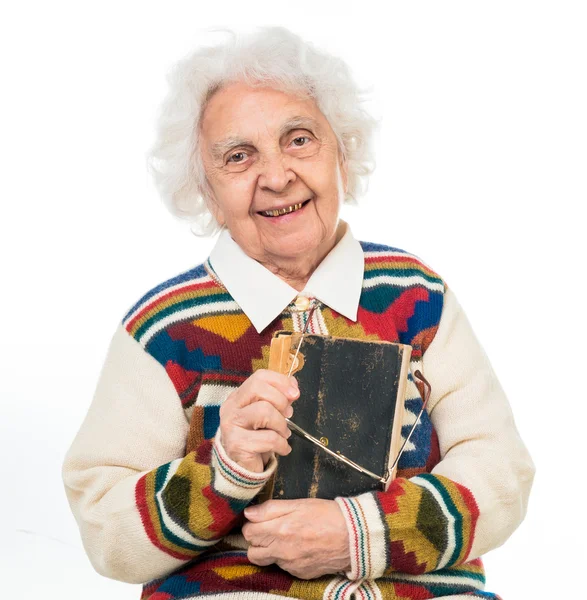 Elderly woman flipping an old book — Stock Photo, Image