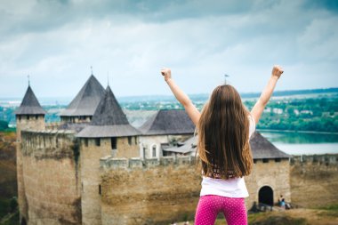 little girl  in front of Khotyn Fortress clipart
