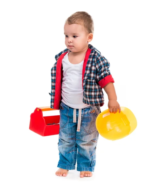 Malý chlapec s hračkou nástrojů a helma — Stock fotografie