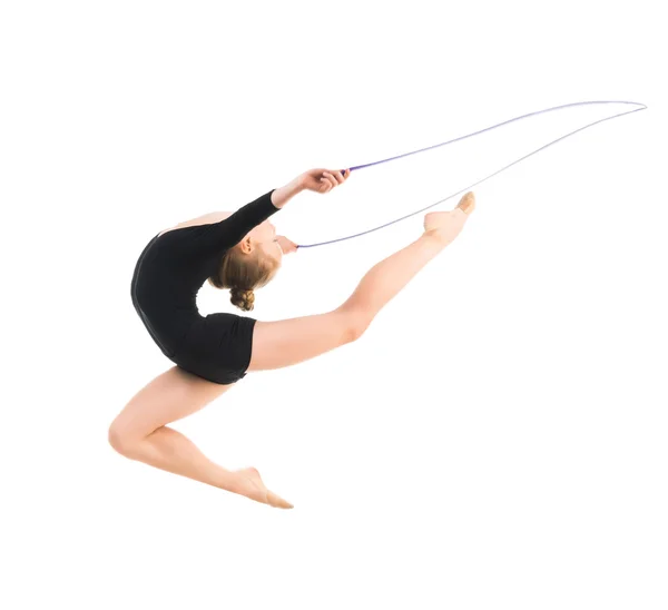 Little gymnast doing exercise with skipping rope — Stock Photo, Image