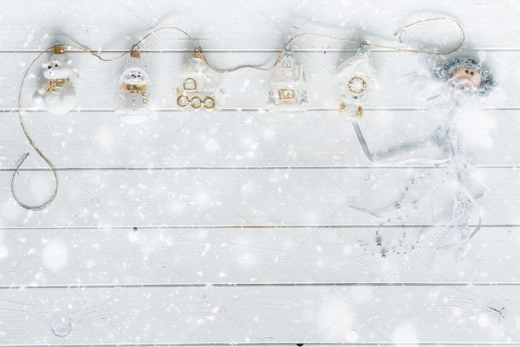 planks under snow and christmas decorations