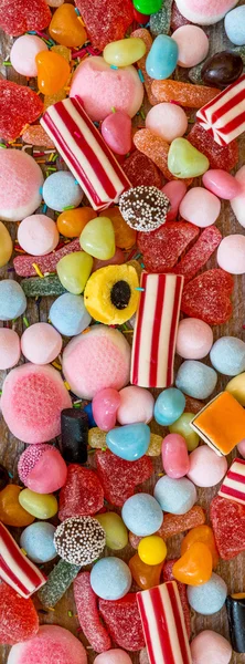 Variety of candies on a wooden background — Stock Photo, Image