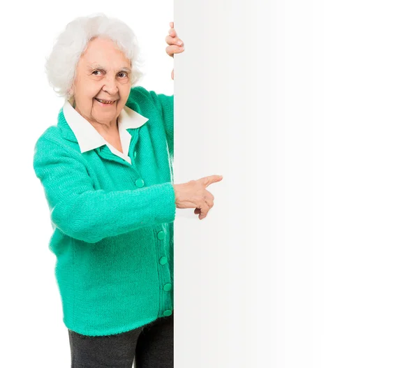 Elderly woman alongside of ad board — Stock Photo, Image