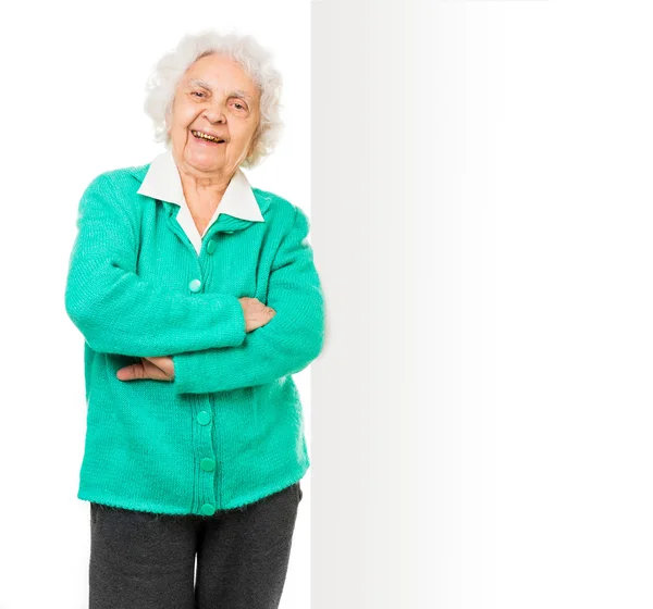 Elderly woman alongside of ad board — Stock Photo, Image