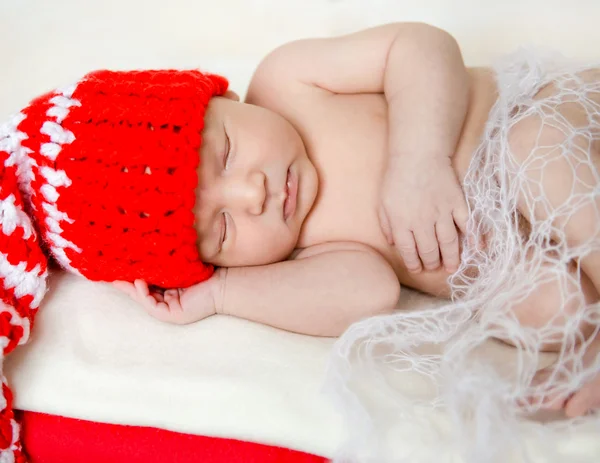 Sleeping newborn baby in christmas decorations — Stock Photo, Image