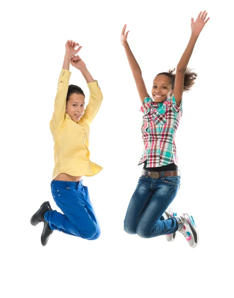 Boy and girl with different complexion jumping — Stock Photo, Image