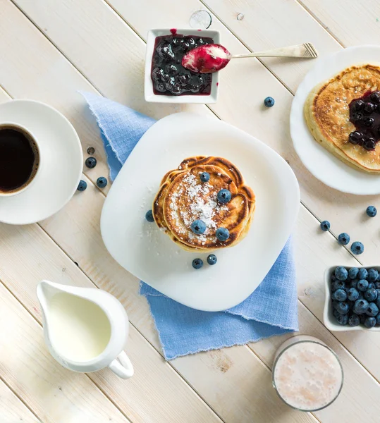 Pannenkoeken met bosbessen en koffie op tafel — Stockfoto