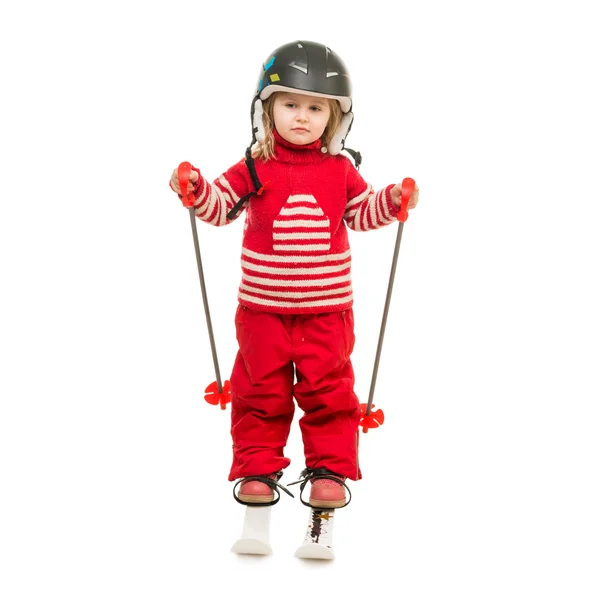Little girl in red ski suit standing on skis — Stock Photo, Image
