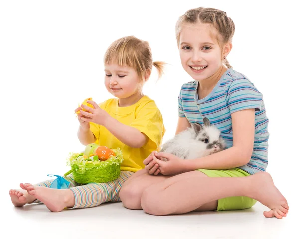 Happy little sisters with her rabbit — Stock Photo, Image