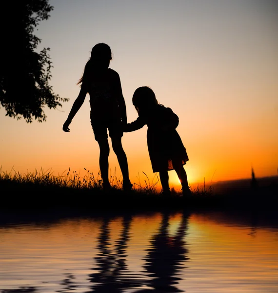 Silhouette of two young sisters — Stock Photo, Image