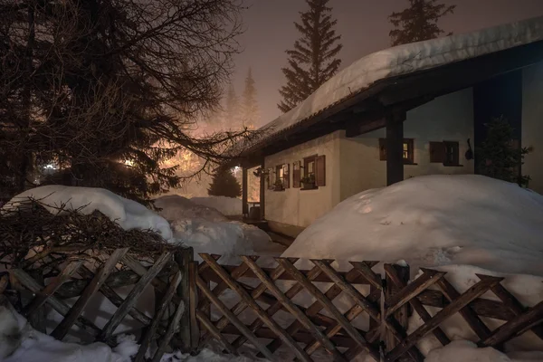 Mountain chalet in winter Alps in night