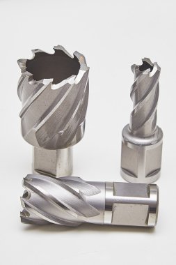 A bunch of heavy duty drill bits on studio white. HSS core drill for metal. clipart