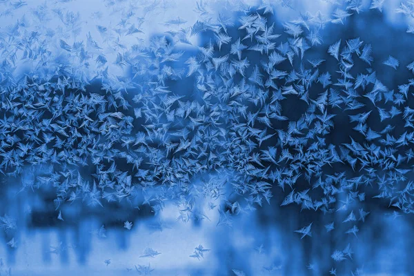 Beautiful ice pattern on winter window, natural close-up background or texture