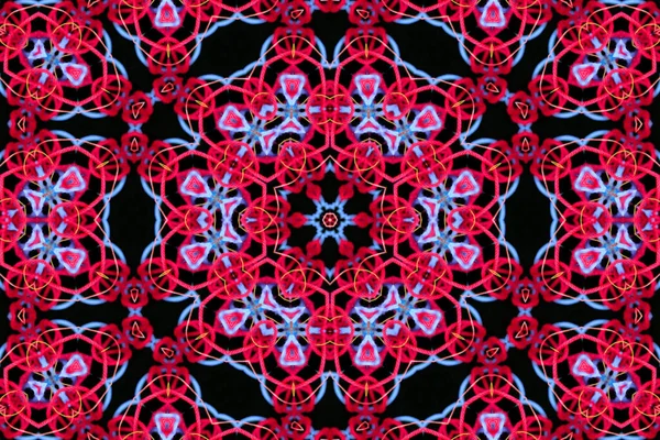 Abstract pattern of bright red and blue threads close-up on a black background