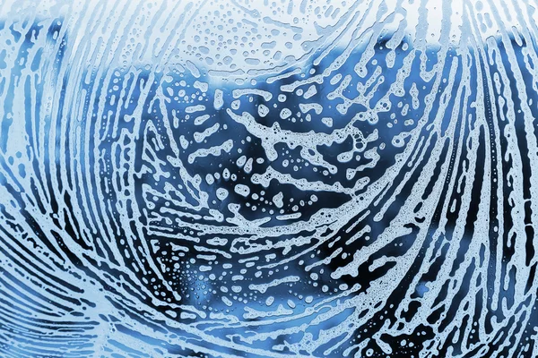 Синий фон с рисунком из пены — стоковое фото
