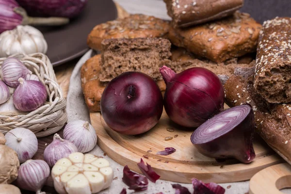 Onion and garlic with a bread — Stock Photo, Image