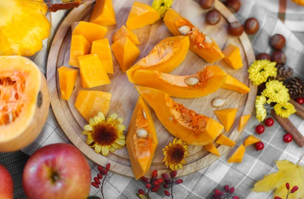 Trozos de calabaza en una tabla de cortar de madera — Foto de Stock