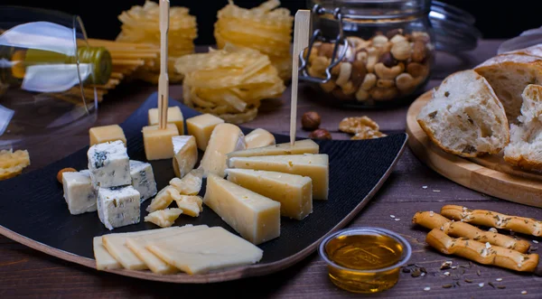 Different cheeses, bread and pasta — Stock Photo, Image