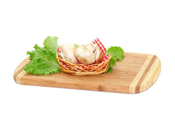 Champignons lying on cutting board — Stock Photo, Image