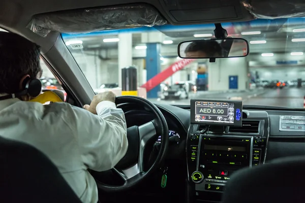 Taxi driver transporting passenger in Dubai