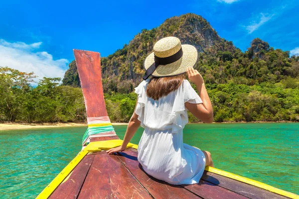 Happy traveler woman relaxing on boat near tropical island