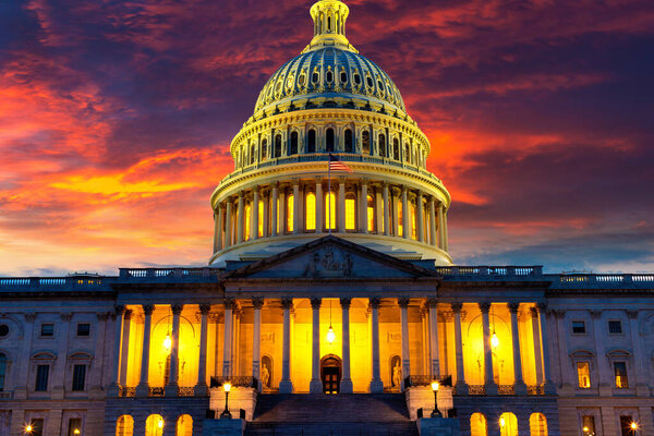 The United States Capitol building at sunset at night in Washington DC, USA