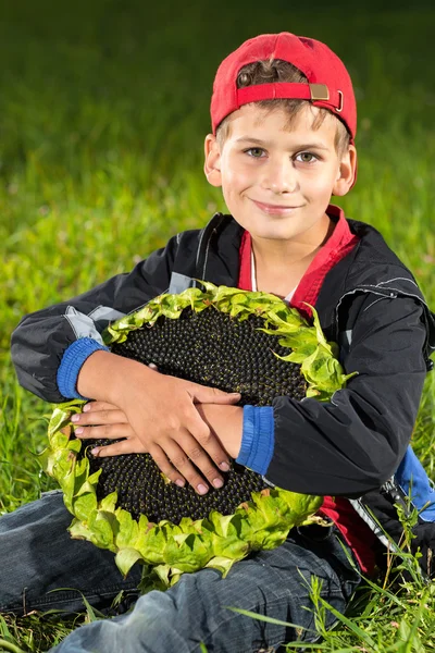 Boy holding sunflower — Stock Photo, Image