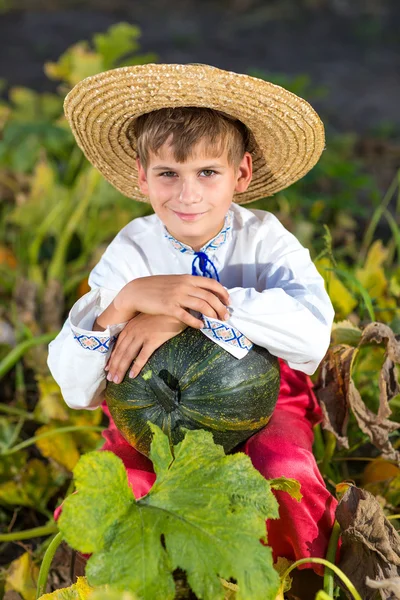 Boy holding pumpkin — Stock Photo, Image