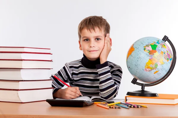 Cute schoolboy writting Royalty Free Stock Images