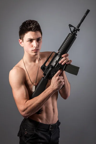 Bare-chested soldier with rifle — Stock Photo, Image