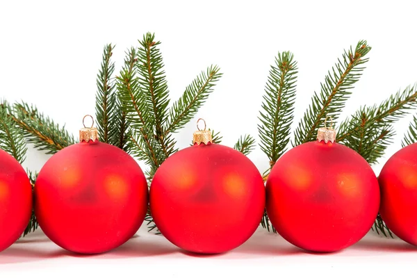 Red Christmas balls and fir branch — Stock Photo, Image