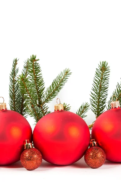 Red Christmas balls and fir branch — Stock Photo, Image