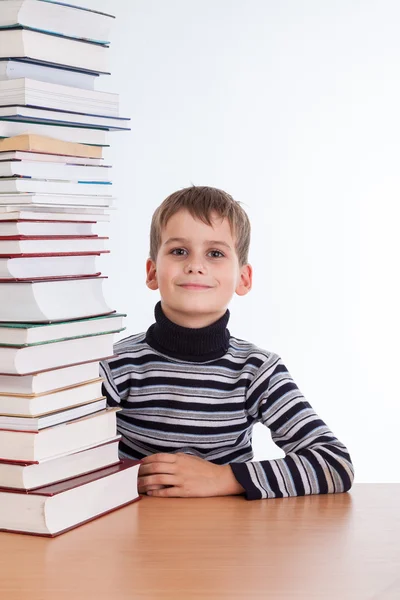 Schoolboy and   heap of books — Stock Photo, Image