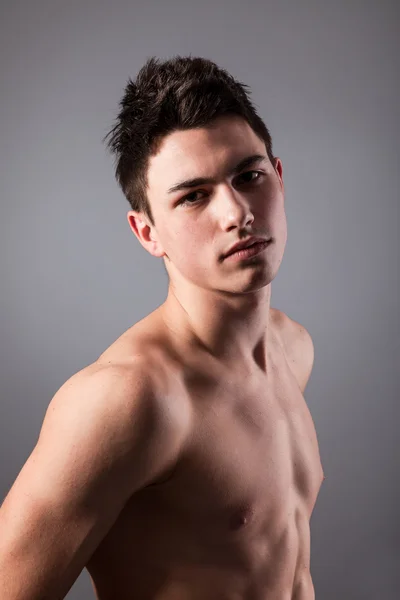 Handsome face of a young man on grey — Stock Photo, Image