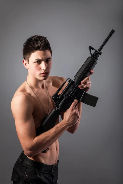 Handsome soldier with rifle — Stock Photo, Image