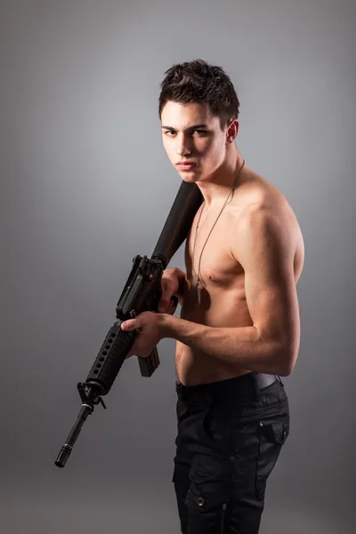 Handsome soldier with rifle — Stock Photo, Image