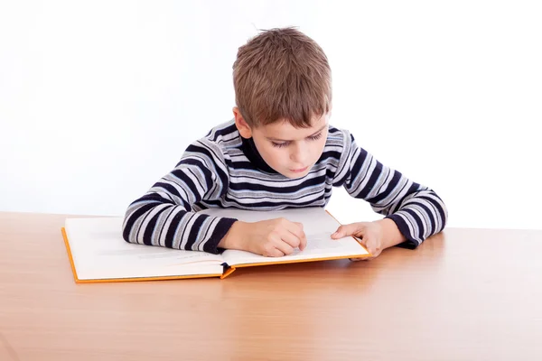 Schoolboy is reading   book — Stock Photo, Image