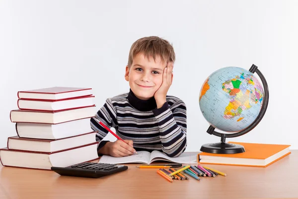 Cute schoolboy is writting Royalty Free Stock Photos