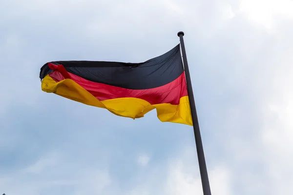 Germany flag in front of blue sky — Stock Photo, Image