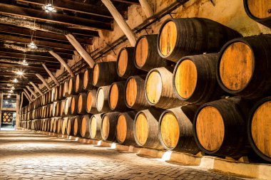 Barrels in  wine cellar in Porto clipart