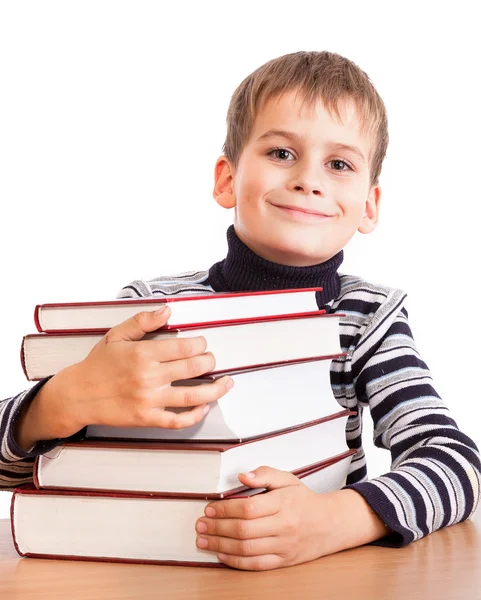 Schoolboy and a heap of books — Stock Photo, Image