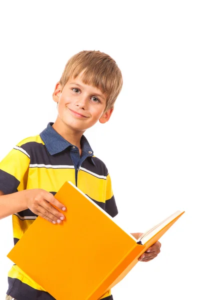 Menino da escola está segurando um livro — Fotografia de Stock