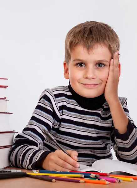 Cute schoolboy is writting — Stock Photo, Image