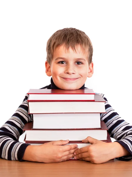 Schoolboy and a heap of books — Stock Photo, Image