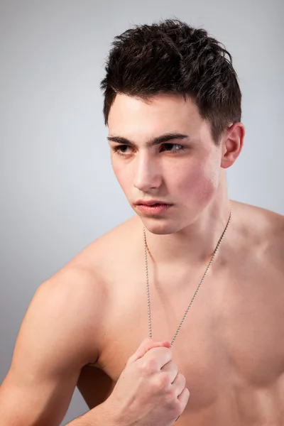 Muscular built man with a dog tags. — Stock Photo, Image