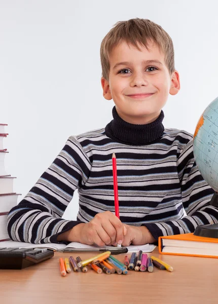 Cute schoolboy is writting — Stock Photo, Image