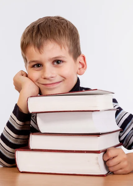 Un écolier et un tas de livres — Photo