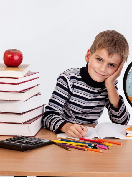 Cute schoolboy is writting — Stock Photo, Image