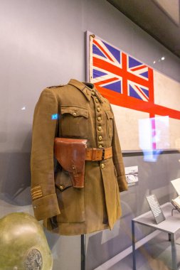 LONDON, İngiltere - 22 Temmuz 2024: Kraliyet Donanması Beyaz Asteğmeninin yanında İngiliz askeri üniforması ve deri kılıfına yakın çekim